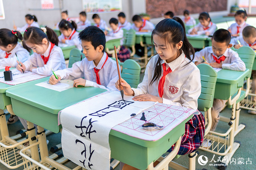 内蒙古呼和浩特市玉泉区恒昌店巷小学学生在书写中秋诗词佳句。丁根厚摄