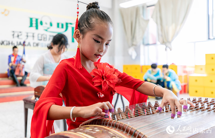 呼和浩特市玉泉区通顺街小学学生课后在活动室学习古筝演奏。丁根厚摄