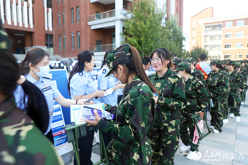 民警向學生發放宣傳冊。王鑫攝