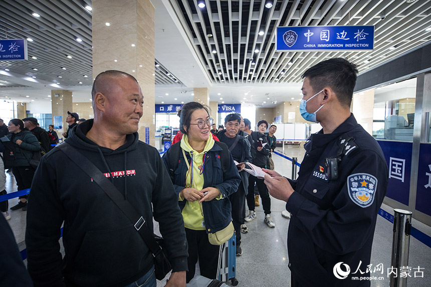 二連出入境邊防檢查站執勤民警為旅客提供通關咨詢。郭鵬杰攝
