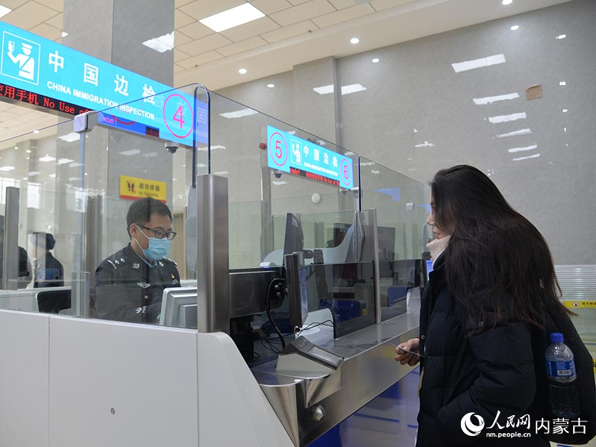 为旅客办理边防检查手续。陈鑫摄