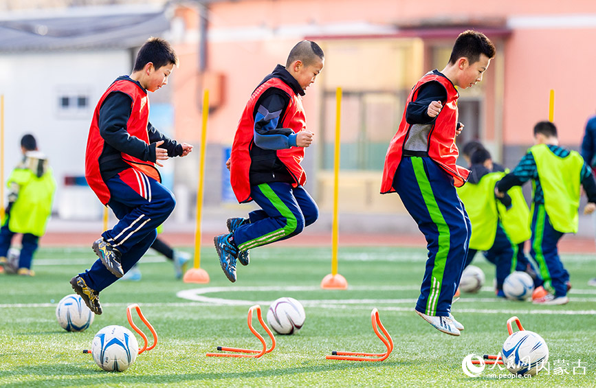 2024年1月8日，呼和浩特市玉泉區南茶坊小學的小球員們在訓練腿部力量。丁根厚攝