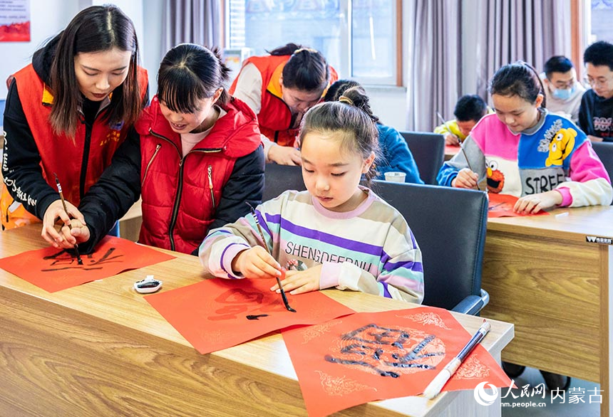 孩子们在“品传统年韵 迎龙年新春”主题活动现场学写中国“福”。丁根厚摄