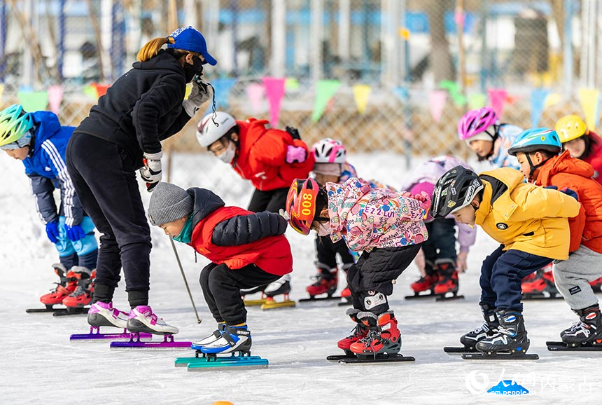 小朋友在内蒙古呼和浩特市青城公园公益冰场学习滑冰。丁根厚摄