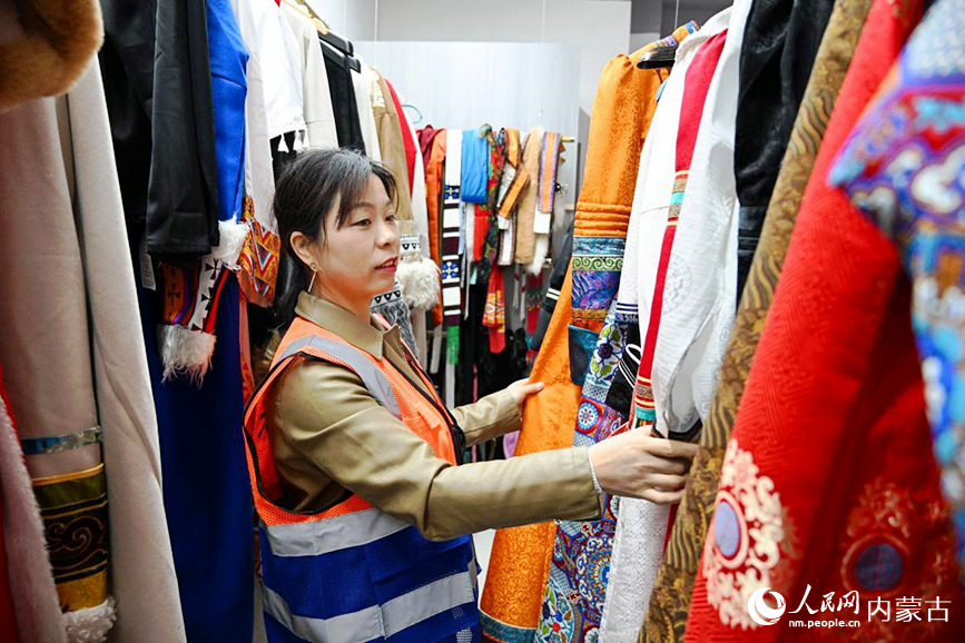 建筑女工挑选拍摄个人写真的服饰。王磊摄