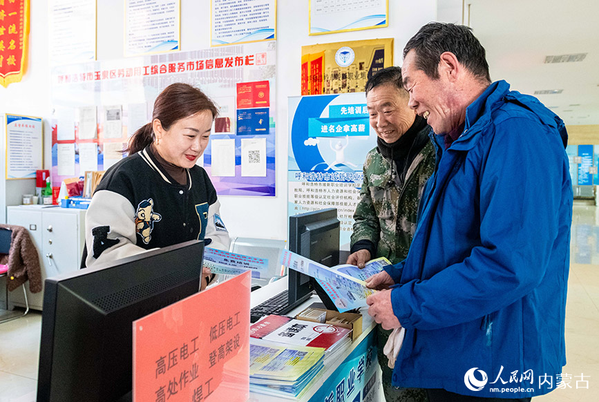 3月18日，工作人员在呼和浩特市玉泉区零工市场为求职者介绍技能培训课程的相关内容。丁根厚摄