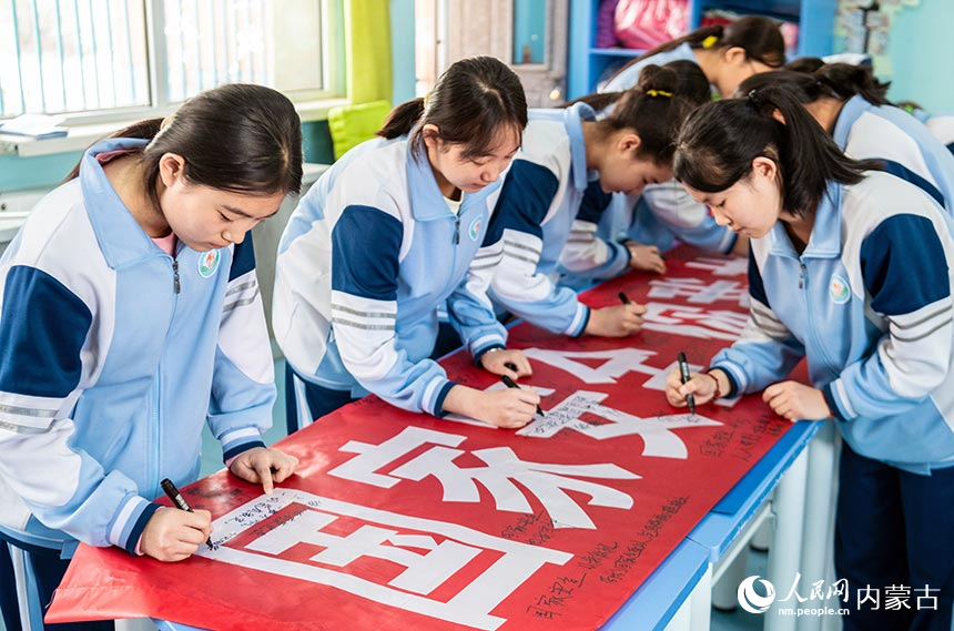呼和浩特市第二十七中学学生参加“国家安全 你我共筑”主题签名活动。丁根厚摄