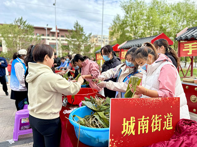 居民互相交流着包粽子经验