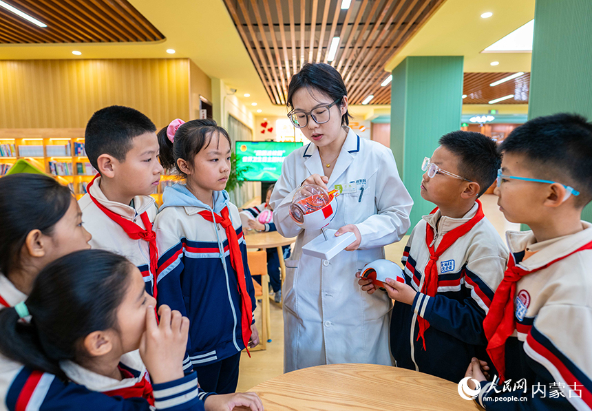 医护志愿者在呼和浩特市第四十三中学向学生们讲解科学用眼防近视知识。丁根厚摄