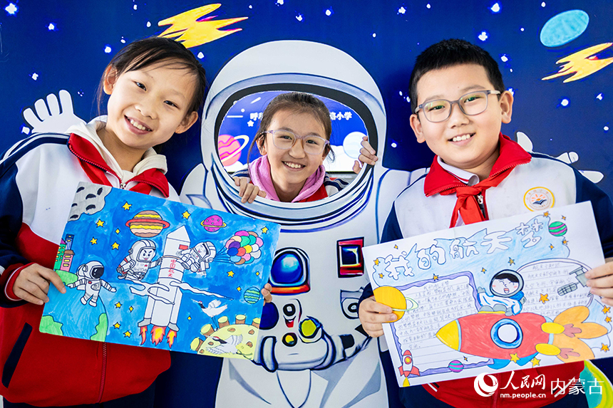 呼和浩特市玉泉區石東路小學學生在中國航天日主題科普活動中展示創作的太空畫。丁根厚攝