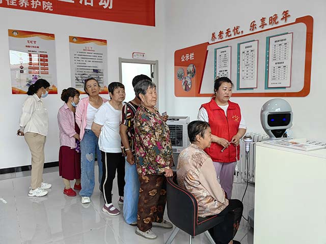 午后的康养区一台AI智能理疗机器人前聚拢了排队等候的老人