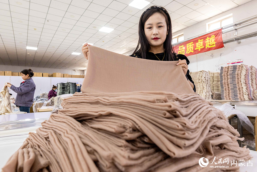 內蒙古呼和浩特市玉泉區裕隆產業園精卓羊絨制品有限公司的生產車間內，工人在生產線上趕制羊絨制品訂單。丁根厚攝