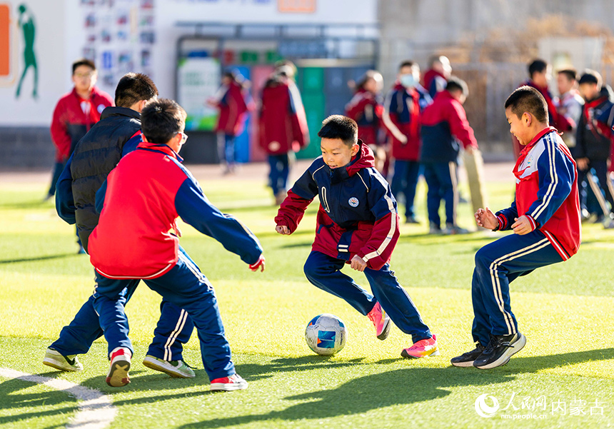 內蒙古呼和浩特市玉泉區石東路小學的學生在操場上進行足球分組對抗賽。丁根厚攝