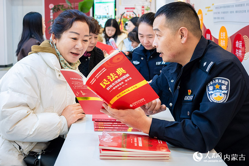 12月4日，呼和浩特市玉泉区公安分局兴隆巷派出所民警为清泉街社区居民讲解民法典知识。丁根厚摄
