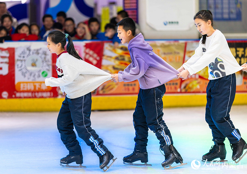 内蒙古呼和浩特市玉泉区小召小学学生在冰场玩趣味游戏。丁根厚摄