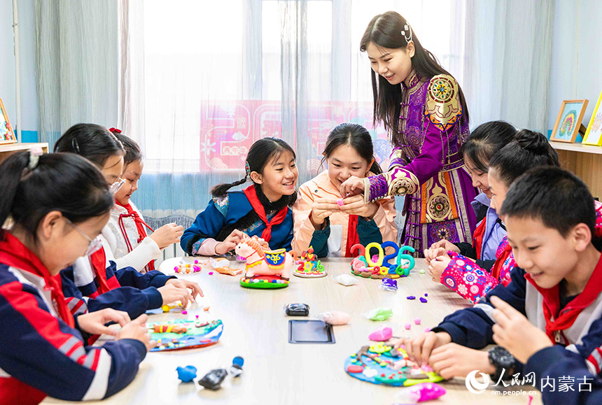 呼和浩特市玉泉区恒昌店巷小学师生在制作以生肖马为主题的彩泥作品。丁根厚摄