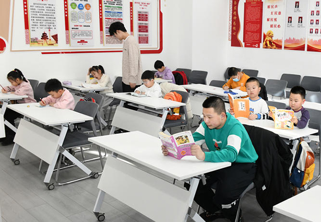 社区公益课堂内大学生志愿者正为孩子们进行作业辅导。张可心摄