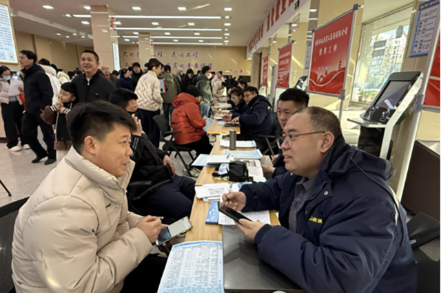 求职者与龙马集团工作人员交谈。王虹燃摄