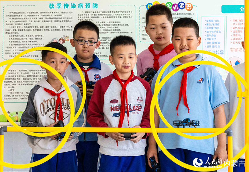 3月26日，呼和浩特市玉泉区通顺街小学无人机社团的学生在进行障碍穿越科目训练。丁根厚摄