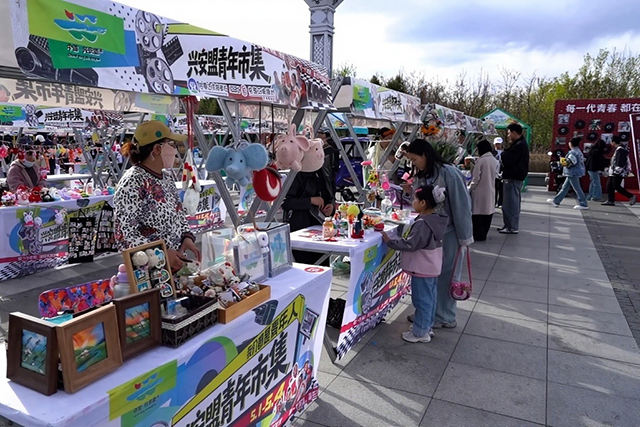 創意文創攤位前，市民游客駐足挑選手作好物，非遺手作、國潮飾品、原創好物琳琅滿目，讓青春創意觸手可及。