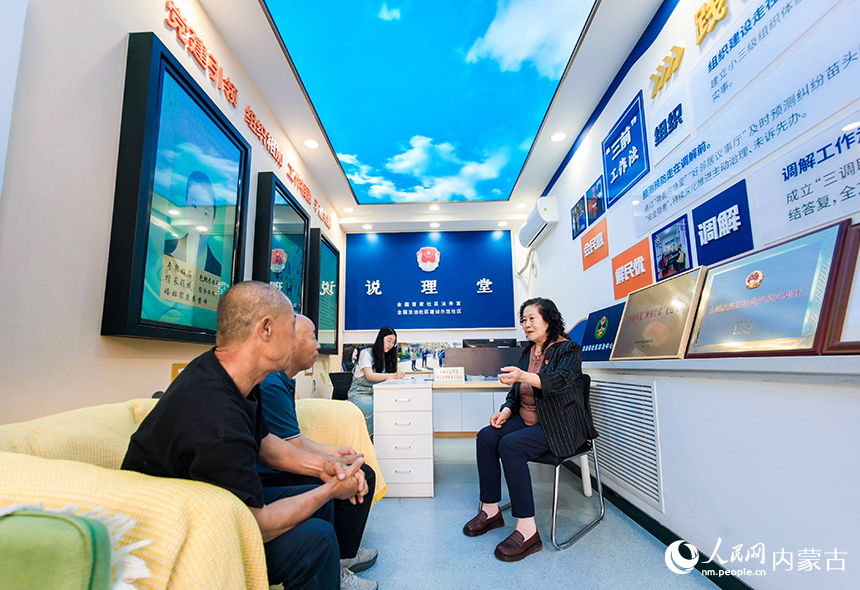 呼和浩特市玉泉區清泉街社區法務室“說理堂”內，工作人員在化解居民糾紛。丁根厚攝