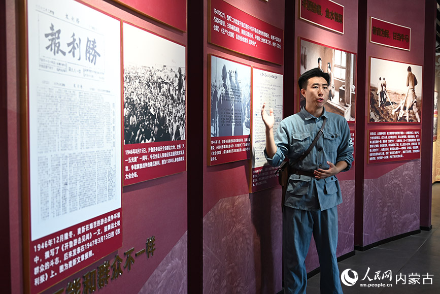 麦新镇宣传干事正在讲解麦新的故事。人民网记者 寇雅楠摄