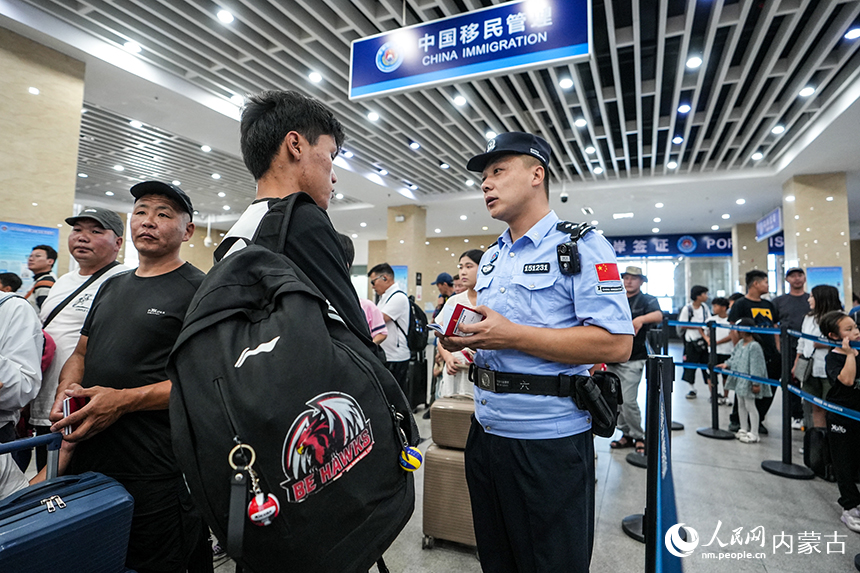 二連出入境邊防檢查站移民管理警察為入境旅客提供通關咨詢。楊金燁攝
